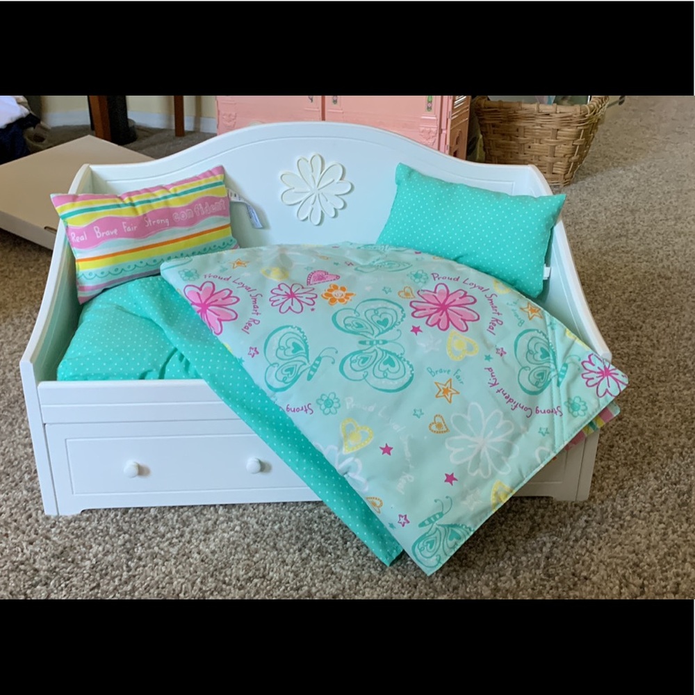Retired American Girl trundle bed with bedding.